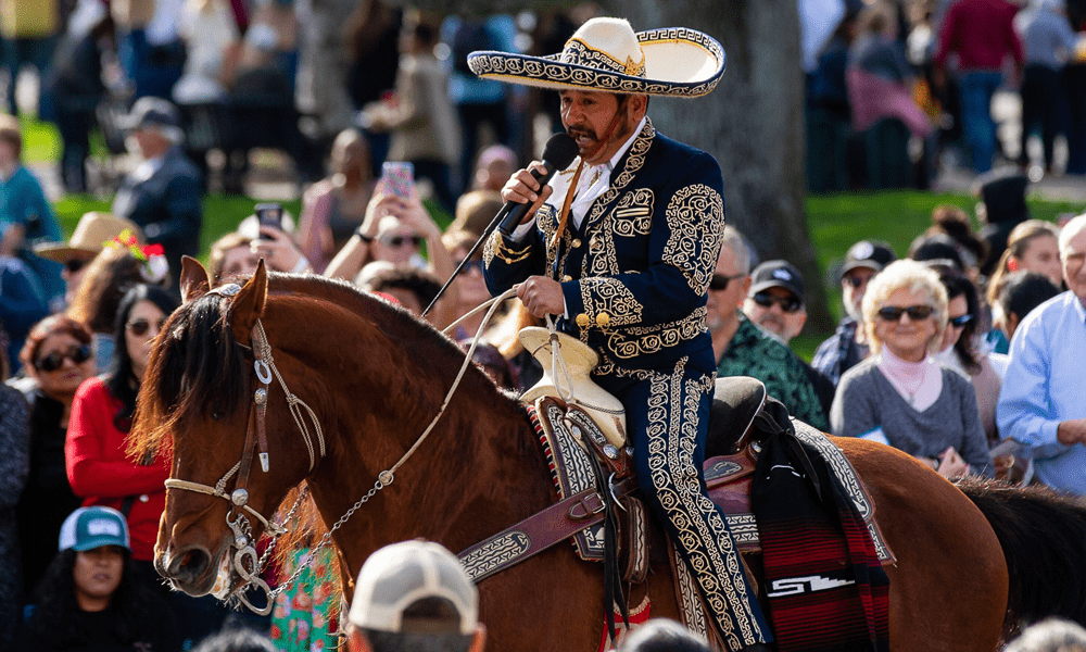 Image of man, Manuel Enrique, riding a dancing horse while singing.